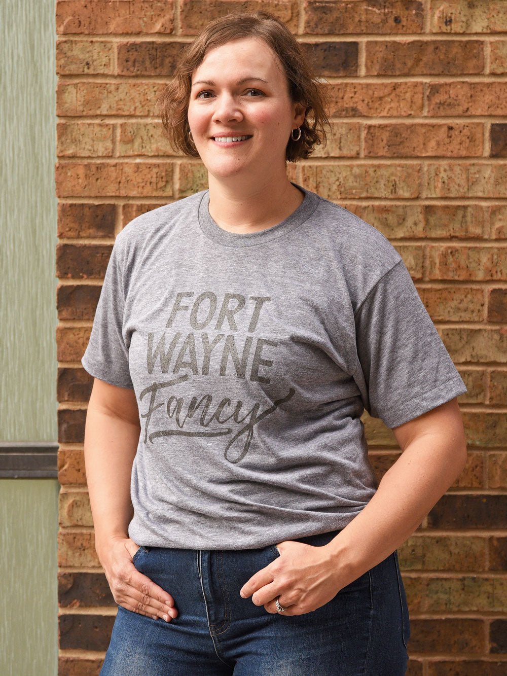 Fort Wayne Fancy gray heather t-shirt on model by brick wall
