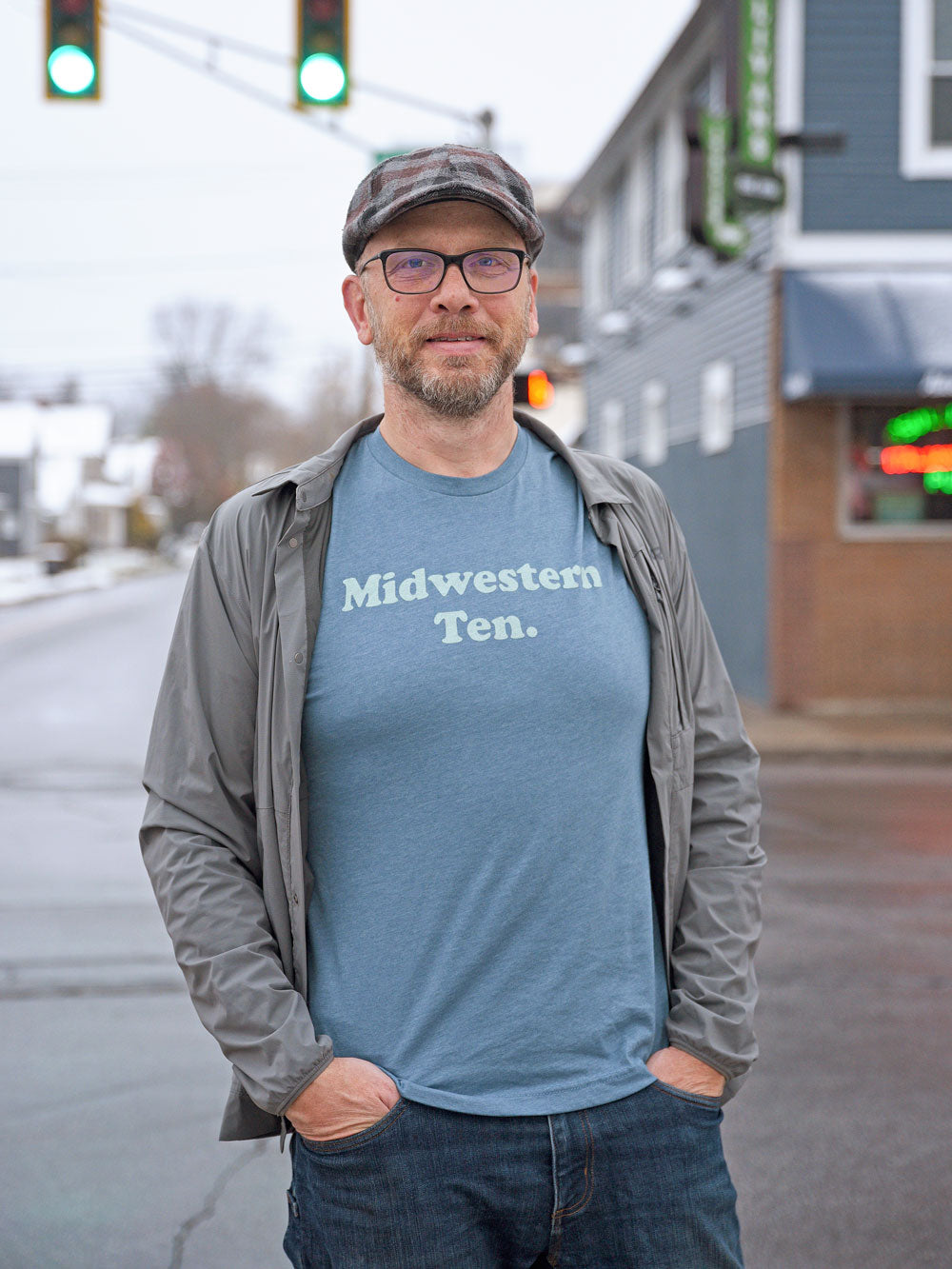 Midwestern Ten slate heather t-shirt on model in front of green traffic lights