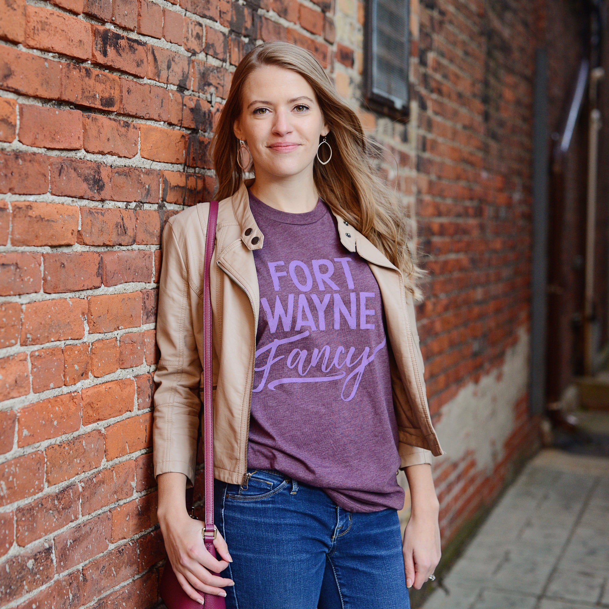 Fort Wayne Fancy plum heather t-shirt on model by brick wall
