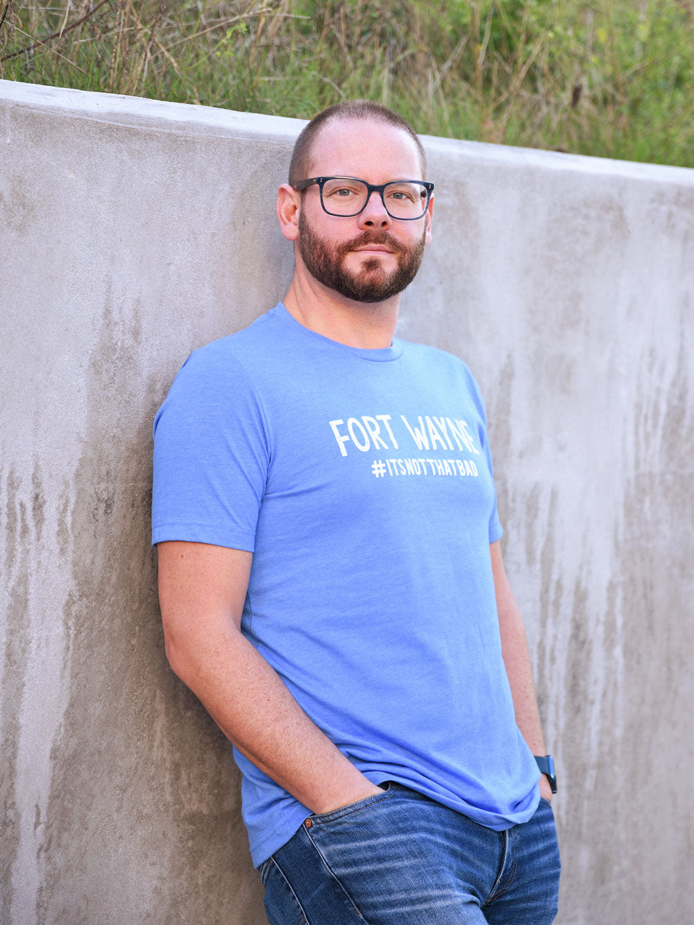 Fort Wayne #itsnotthatbad blue heather t-shirt on model by concrete wall