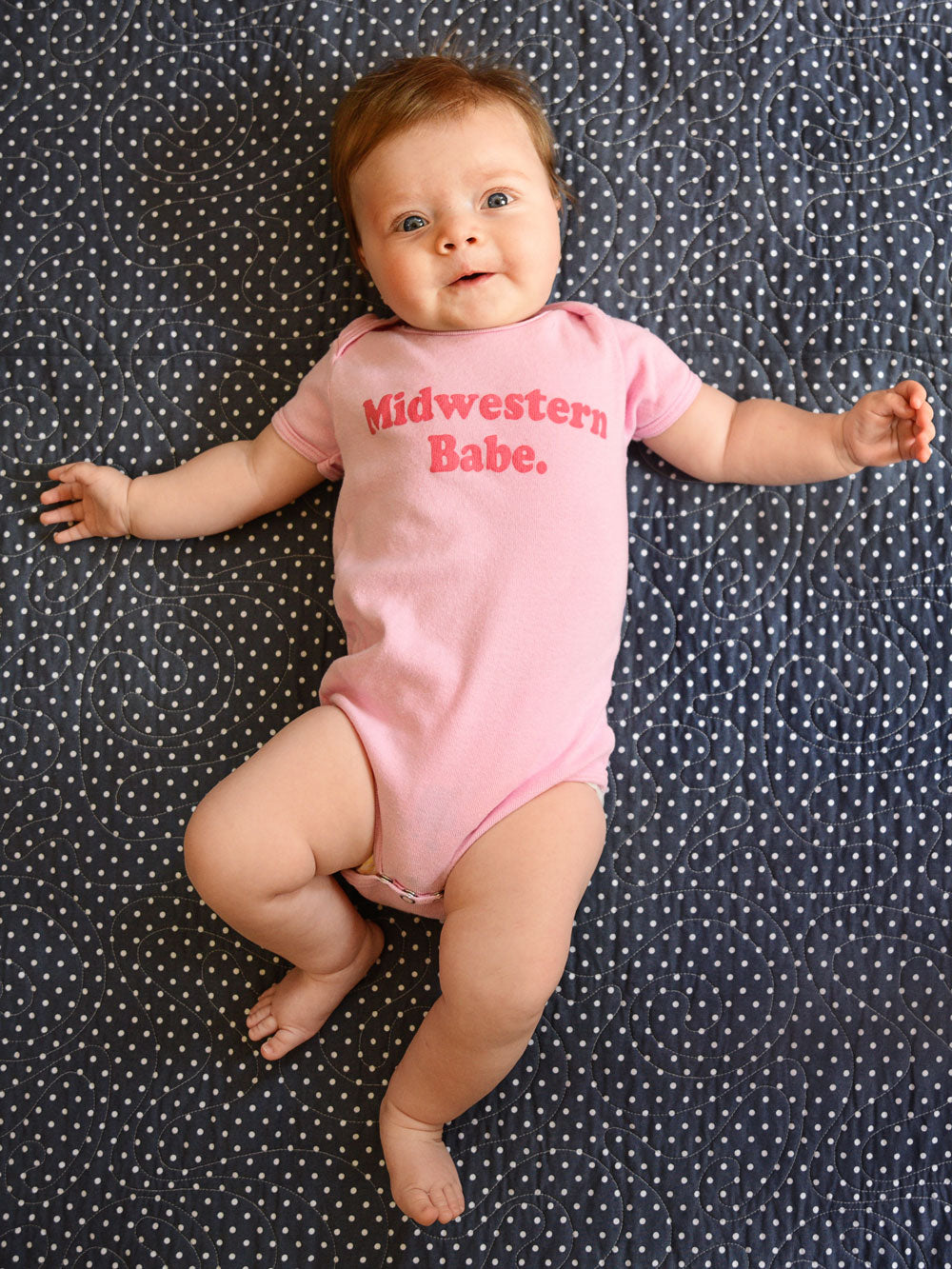 Midwestern Babe pink infant bodysuit on baby on navy blanket