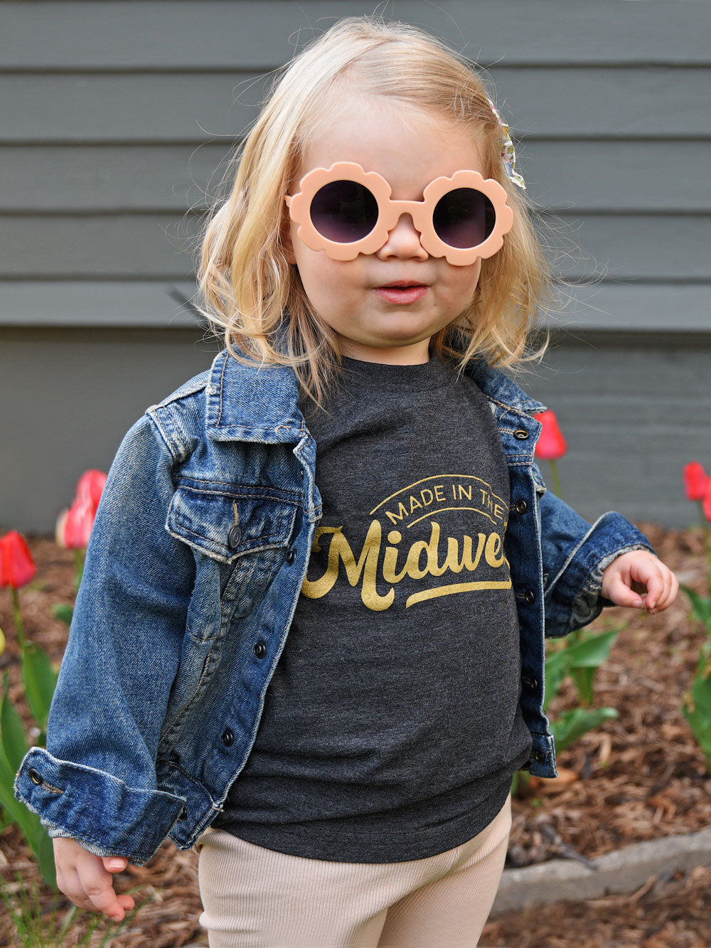 Made in the Midwest black heather kids t-shirt on toddler with flower sunglasses